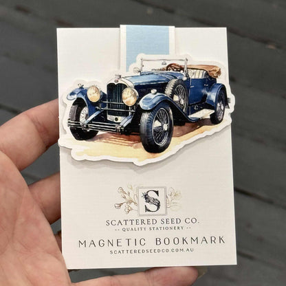 Hand holding a magnetic bookmark with a vintage car design - The Book Keeper and Co