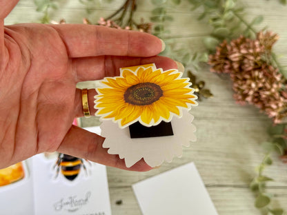Hand holding a sunflower-shaped magnetic Bookmark - The Book Keeper & Co
