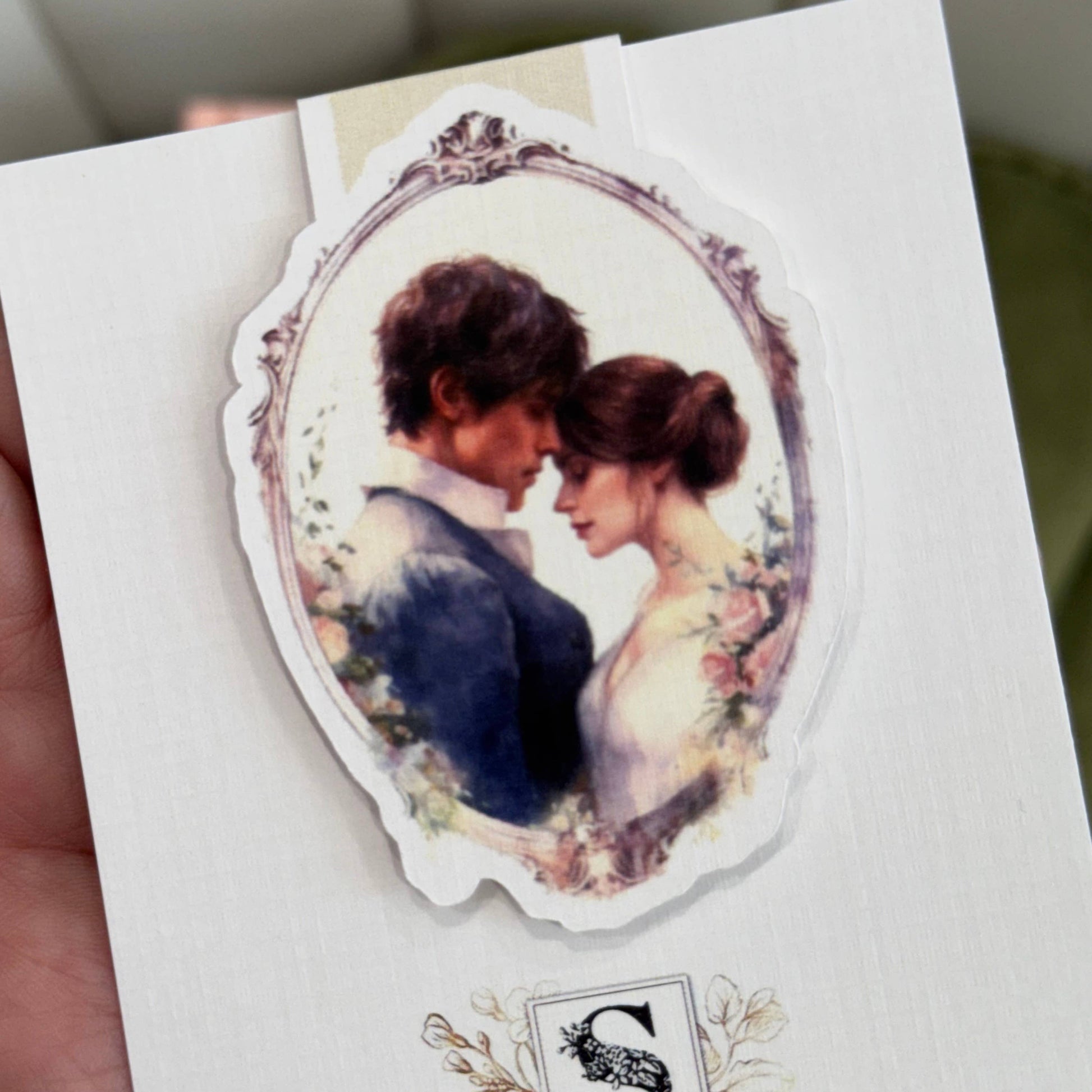 Sticker of a couple in an oval frame on a white card - The Book Keeper & Co