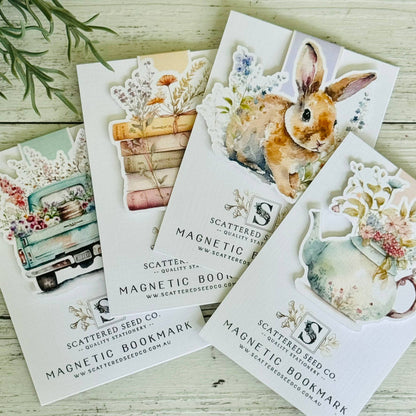 Set of magnetic bookmarks with illustrations on a wooden surface - The Book Keeper and Co