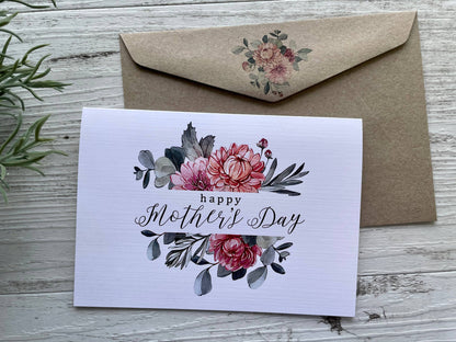 Mother's Day card with floral design and matching envelope on a wooden surface