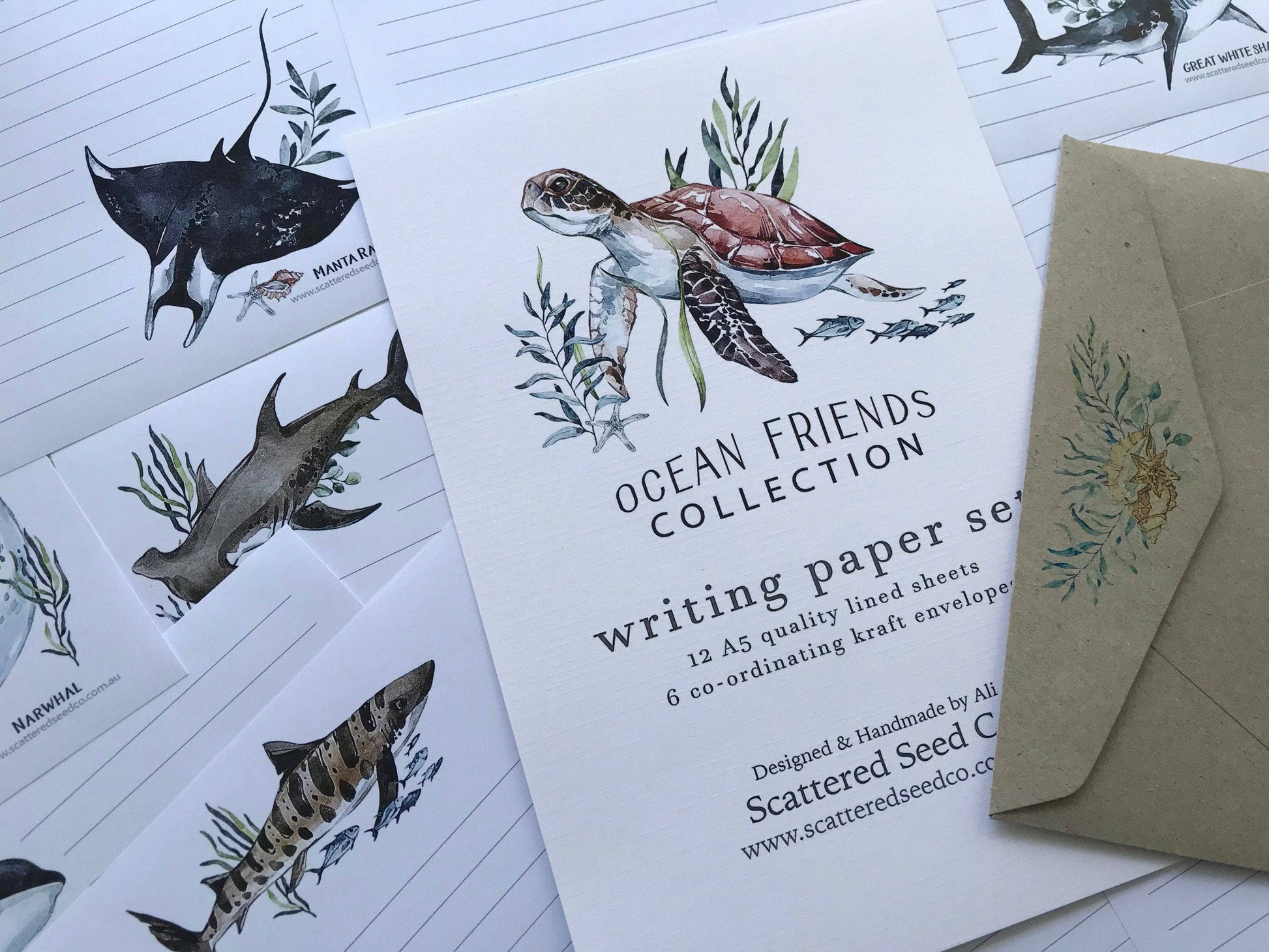 Writing paper set with ocean-themed design featuring a turtle and shark, accompanied by a matching envelope.