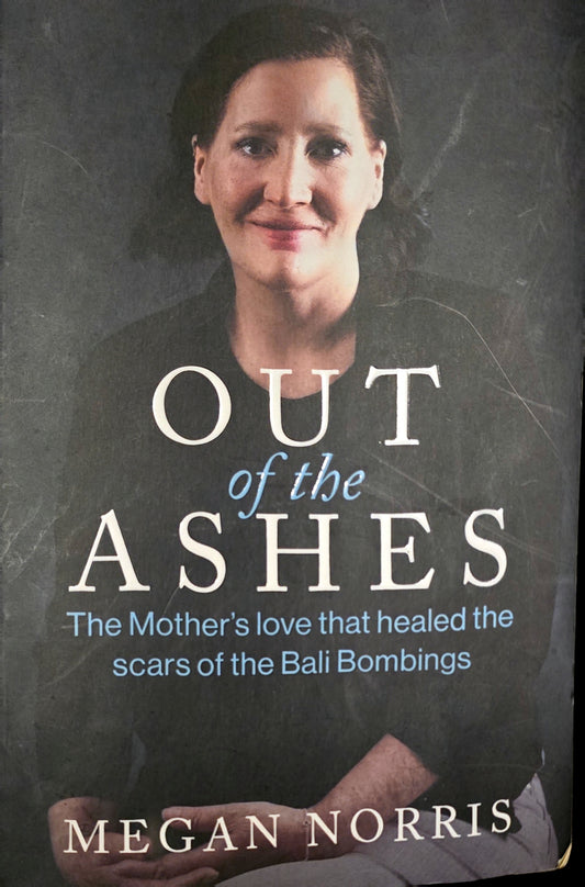 Book cover of 'Out of the Ashes' by Megan Norris featuring a woman's face.