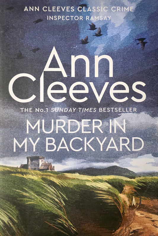 Book cover of 'Murder in My Backyard' by Ann Cleeves with a scenic background.