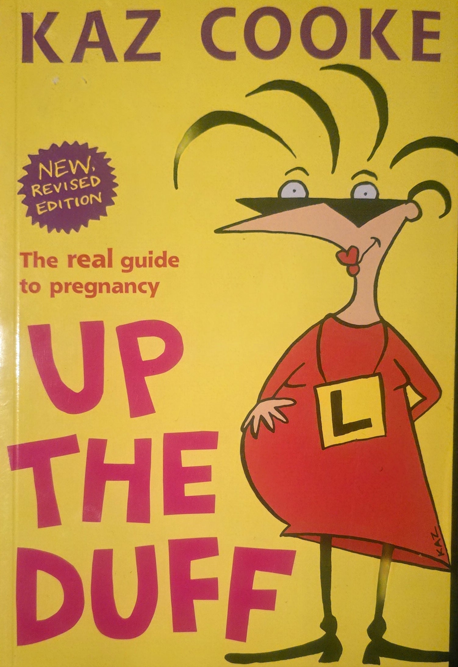 Book cover of 'Up the Duff' by Kaz Cooke with a cartoon character on a yellow background