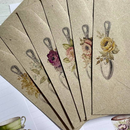 Set of decorative envelopes with floral designs on a textured surface