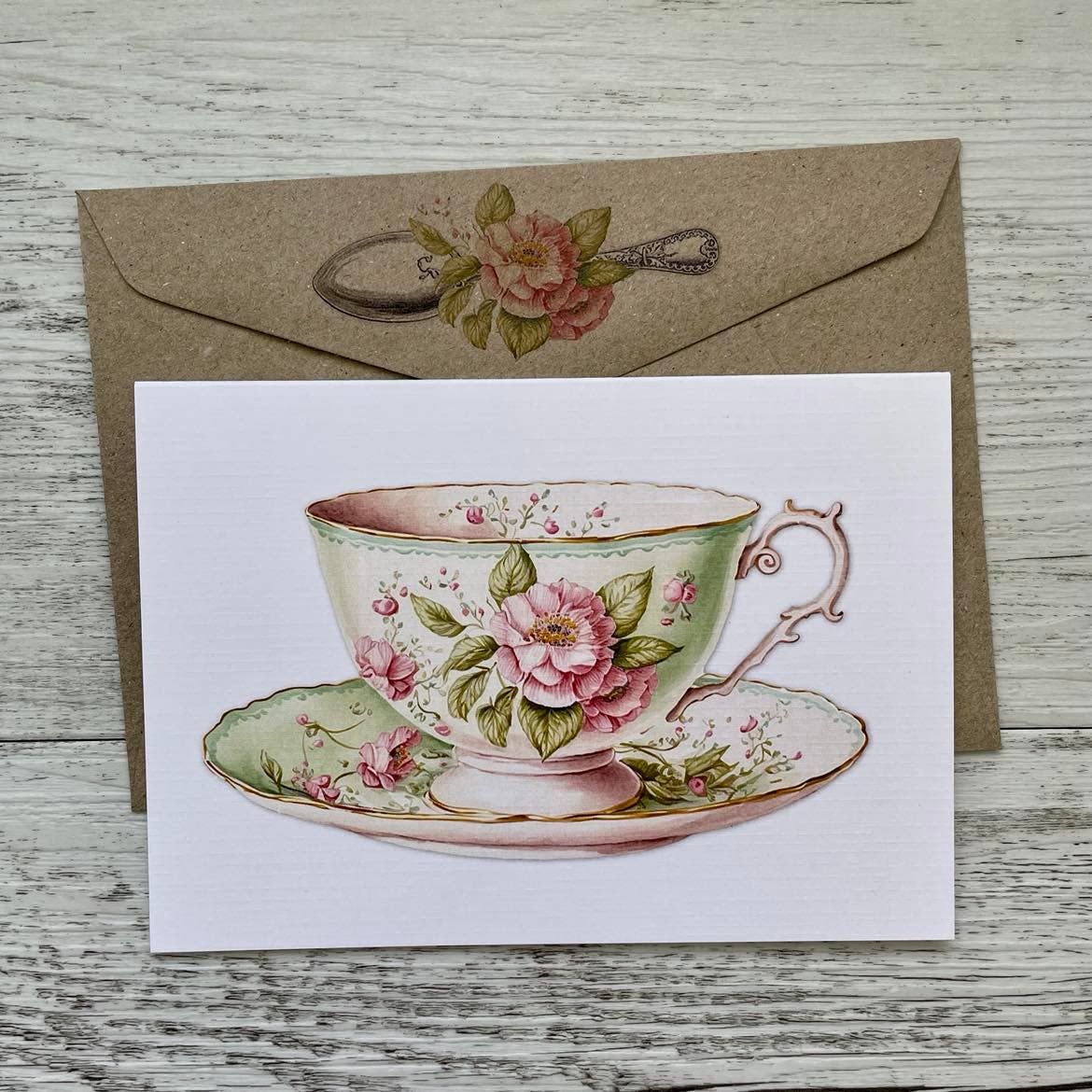 Card with a vintage floral teacup design on a wooden surface - The Book Keeper and Co