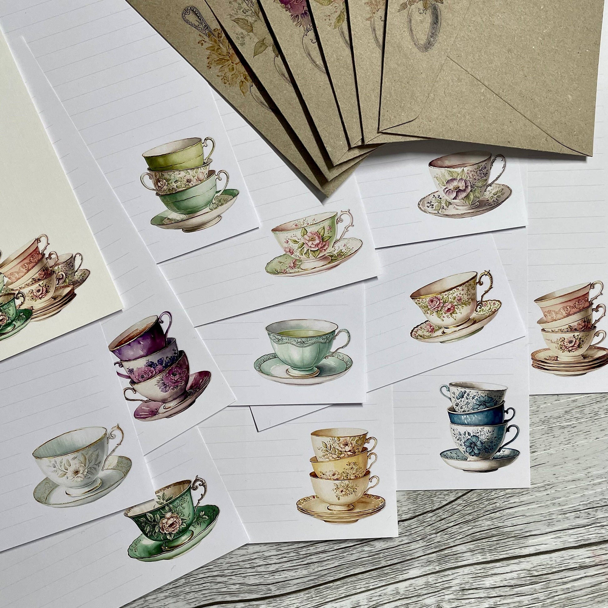 Stylized illustrations of vintage teacups and saucers on stationery cards with envelopes.